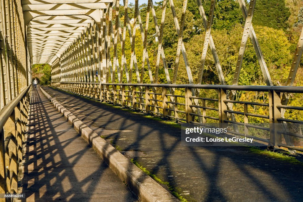 Old iron footbridge photographed on an early sunny morning