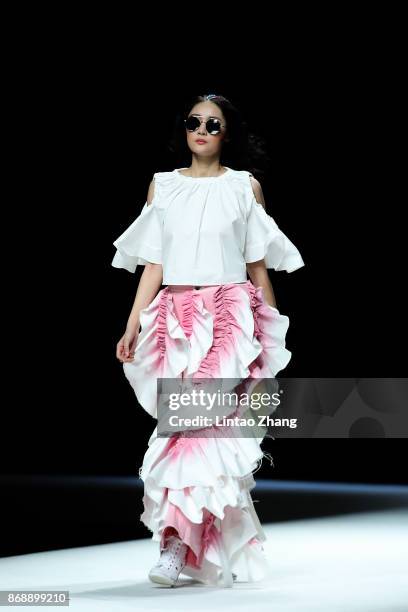 Model showcases designs on the runway at the M.X Collection show by designer Yang Shan during the Mercedes-Benz China Fashion Week Spring/Summer 2018...