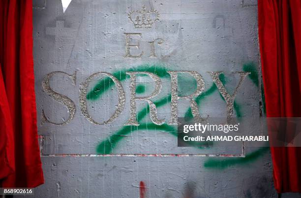 Carving in stone reading "ER, Sorry" playing on the common initials for Queen Elizabeth Regina are seen on the controversial Israeli separation...