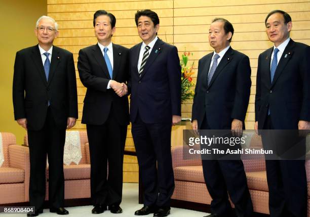 Prime Minister and ruling Liberal Democratic Party President Shinzo Abe and junior coalition Komeito leader Natsuo Yamaguchi shake hands during their...