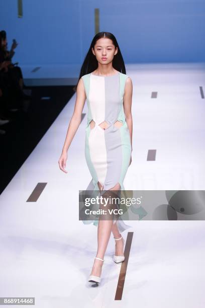 Model showcases designs on the runway at Nuoyi collection by designer Qin Wanyu during the Mercedes-Benz China Fashion Week Spring/Summer 2018 at...