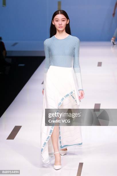 Model showcases designs on the runway at Nuoyi collection by designer Qin Wanyu during the Mercedes-Benz China Fashion Week Spring/Summer 2018 at...