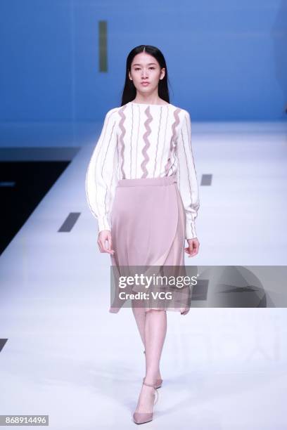 Model showcases designs on the runway at Nuoyi collection by designer Qin Wanyu during the Mercedes-Benz China Fashion Week Spring/Summer 2018 at...