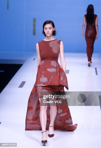 Model showcases designs on the runway at Nuoyi collection by designer Qin Wanyu during the Mercedes-Benz China Fashion Week Spring/Summer 2018 at...