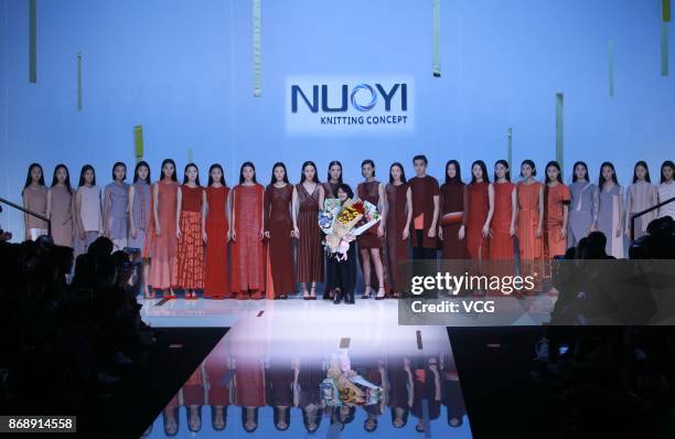 Models showcase designs on the runway at Nuoyi collection by designer Qin Wanyu during the Mercedes-Benz China Fashion Week Spring/Summer 2018 at...