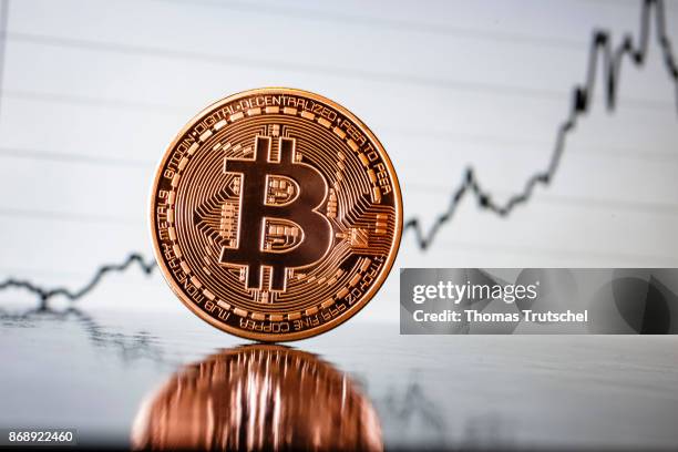 In this photo illustration a model Bitcoin is placed in front of an diagramm on November 01, 2017 in Berlin, Germany.