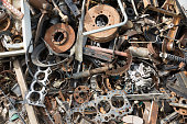 Old rusty corroded car parts in car scrapyard. Car recycling.Wrecking Machinery Parts wait for reused or to be a part for repair.