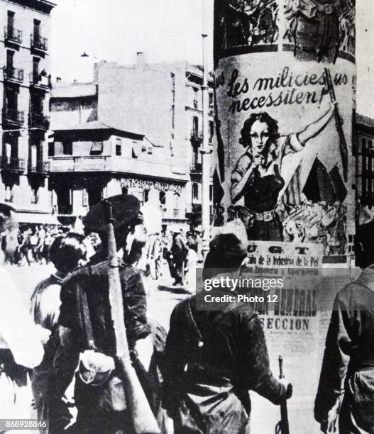 Recruitment poster in Barcelona attracts onlookers during the Spanish civil war.