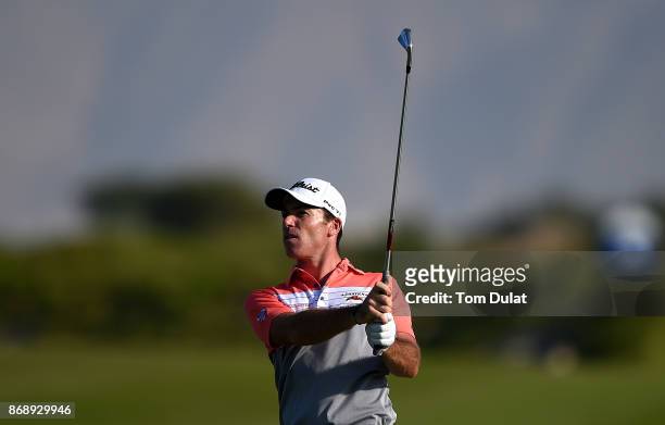 Julien Guerrier of France takes a shot from the 18th fairway on Day One of the NBO Golf Classic Grand Final - European Challenge Tour at Al Mouj Golf...