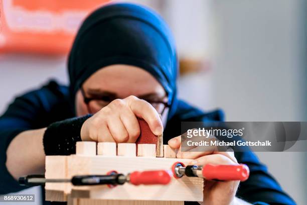 Berlin, Germany A refugee woman wearing a headscarf works at excercise workshop of Berlin chamber of crafts on October 01, 2017 in Berlin, Germany.
