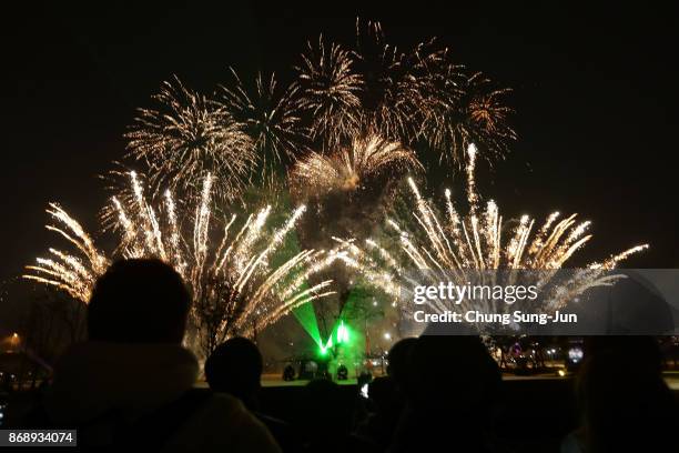 Fireworks explode to celebrate 100 days to go and the PyeongChang 2018 Winter Olympics torch during a torch relay on November 1, 2017 in Incheon,...