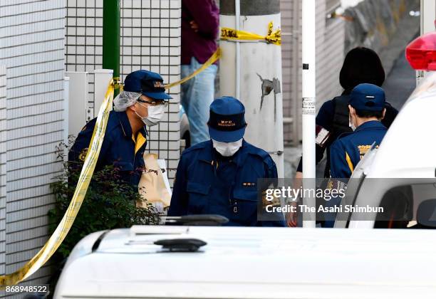 Police officers investigate the apartment where the body parts of nine people were found on November 1, 2017 in Zama, Kanagawa, Japan. Shiraishi,...