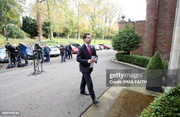 Britain's Northern Ireland Secretary James Brokenshire returns inside after speaking to the media to give an update on the negotiations in Northern...