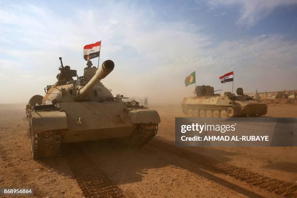 Iraqi forces and Hashed al-Shaabi advance towards the city of al-Qaim, in western Anbar province, on the Syrian border as they fight against remnant...