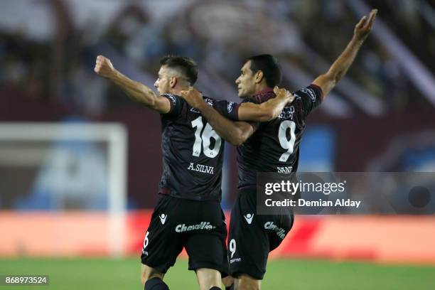 Alejandro Silva of Lanus celebrates with teammate Jose Sand after scoring the fourth goal of his team during a second leg match between Lanus and...