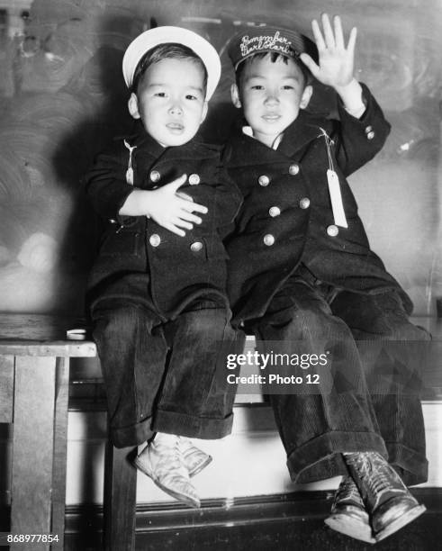 Photograph of the evacuation of two Japanese boys from San Francisco as a result of the Pearl Harbour attacks. Dated 1942.