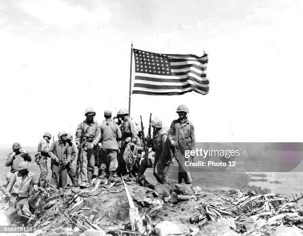 Battle of Iwo Jima. Photo taken during flag raising on volcano top.