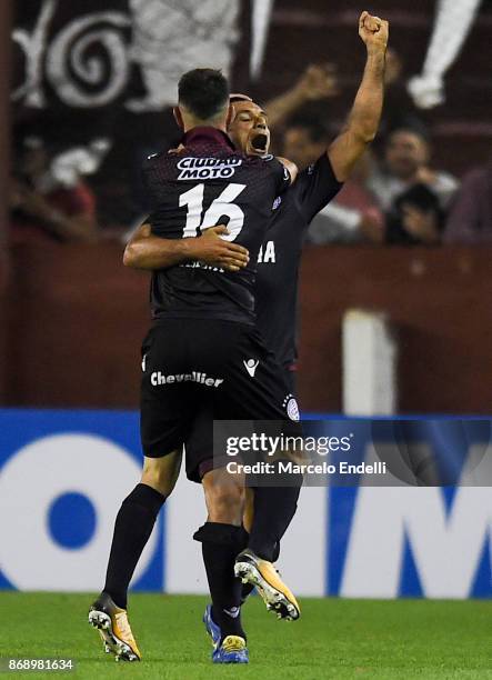 Alejandro Silva of Lanus celebrates with teammate Jose Sand after scoring the fourth goal of his team during a second leg match between Lanus and...