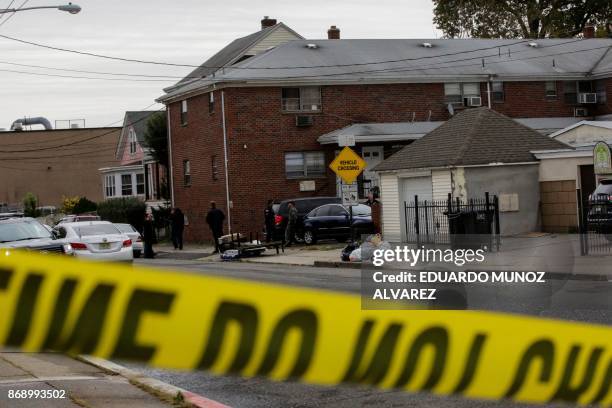 Officers and New Jersey police officers walk outside of suspect Sayfullo Saipov's apartment on November 1 in Paterson, New Jersey. A pickup driver...