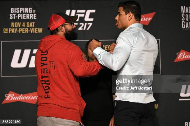 Opponents Johny Hendricks and Paulo Borrachinha of Brazil face off during the UFC 217 Ultimate Media Day inside the Theater Lobby at Madison Square...