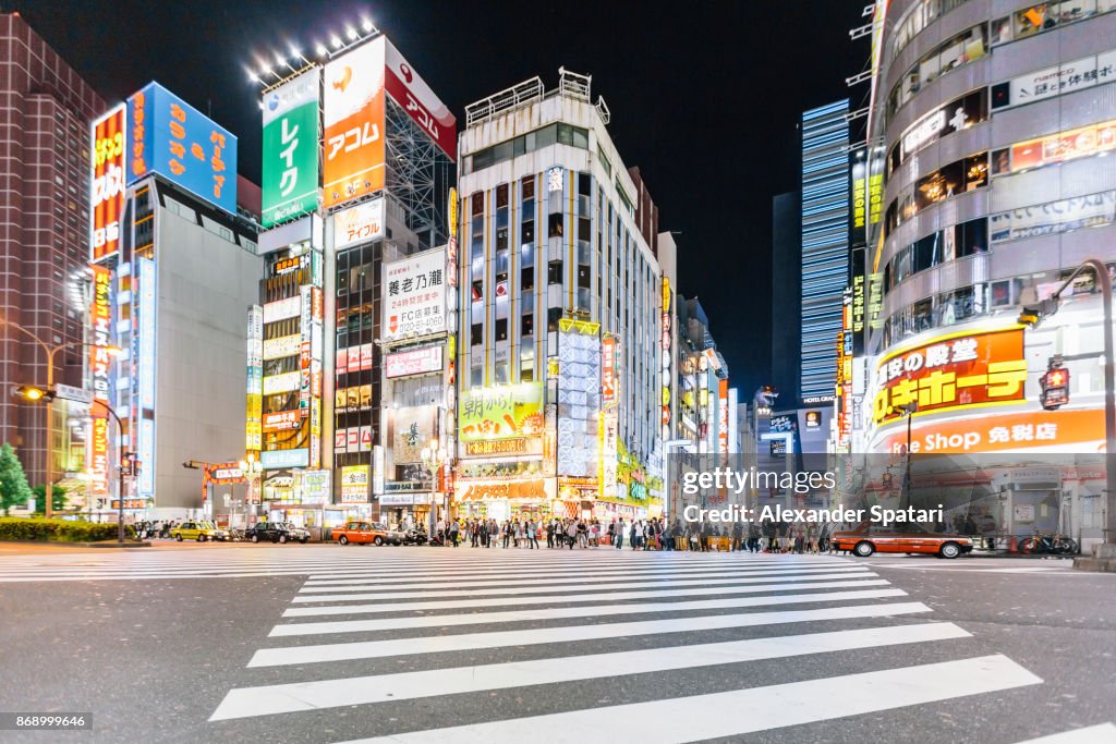 Crosswalk in Shinjuku district at night, Tokyo, Japan