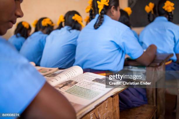 Satia, India School girls in uniform are reading in their classroom in a school in Satia, a small settlement 300 Kilometer from Kalkutta.