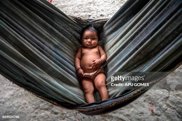 Waiapi toddler at the Manila village at Waiapi indigenous reserve in Amapa state in Brazil on October 14, 2017. The tiny Waiapi tribe is resisting...