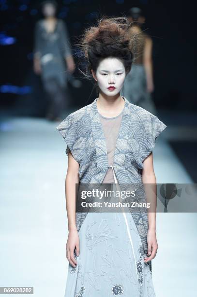 Model showcases designs on the runway at the Ae'lkemi + 33 Poets fashion show by during the Mercedes-Benz China Fashion Week Spring/Summer 2018...