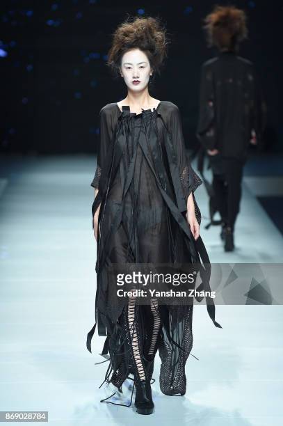 Model showcases designs on the runway at the Ae'lkemi + 33 Poets fashion show by during the Mercedes-Benz China Fashion Week Spring/Summer 2018...