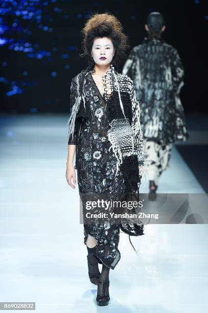 Model showcases designs on the runway at the Ae'lkemi + 33 Poets fashion show by during the Mercedes-Benz China Fashion Week Spring/Summer 2018...
