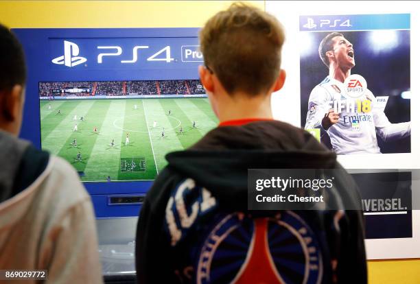 Gamers play the video game 'FIFA 18' developed and published by Electronic Art on a Sony PlayStation game consoles PS4 Pro during the 'Paris Games...