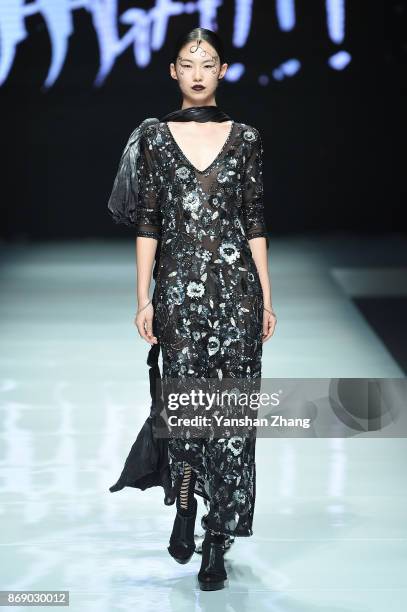 Model showcases designs on the runway at the Ae'lkemi + 33 Poets fashion show by during the Mercedes-Benz China Fashion Week Spring/Summer 2018...