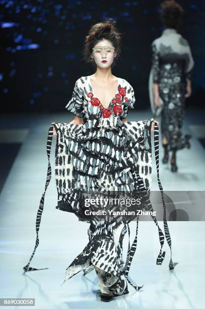 Model showcases designs on the runway at the Ae'lkemi + 33 Poets fashion show by during the Mercedes-Benz China Fashion Week Spring/Summer 2018...