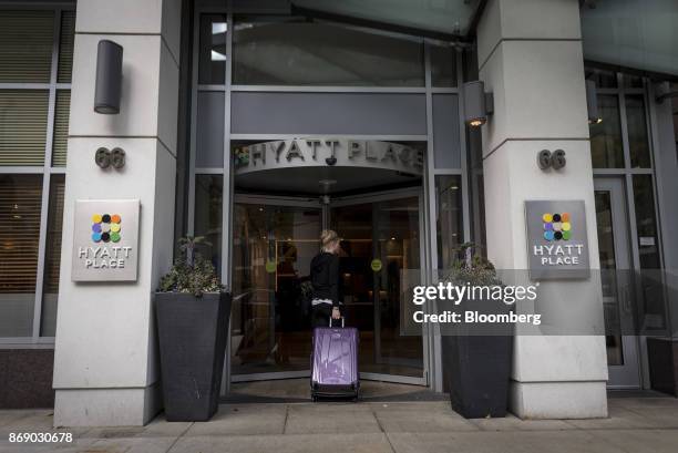 Visitor carries luggage while entering the Hyatt Place hotel in Chicago, Illinois, U.S., on Monday, Oct. 30, 2017. Hyatt Hotels Corp. Is scheduled to...