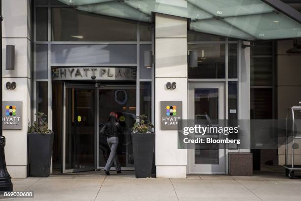 Visitor enters the Hyatt Place hotel in Chicago, Illinois, U.S., on Monday, Oct. 30, 2017. Hyatt Hotels Corp. Is scheduled to release earnings...