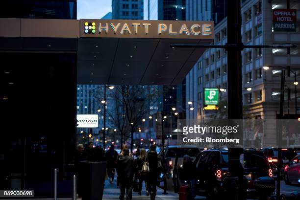 Pedestrians pass in front of the Hyatt Place hotel in Chicago, Illinois, U.S., on Monday, Oct. 30, 2017. Hyatt Hotels Corp. Is scheduled to release...