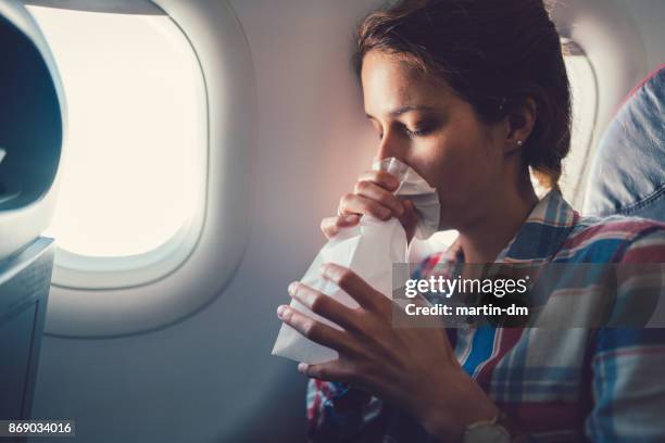 sick woman with nausea in the airplane - illness stock pictures, royalty-free photos & images