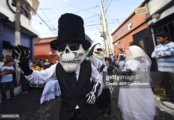 Revellers take part in the traditional "Convite de fieros" festival, as part of All Saints Day celebrations in Villa Nueva, 25 km south of Guatemala...