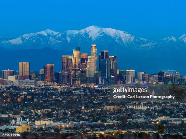 los angeles skyline with snow capped mountains - downtown los angeles aerial stock pictures, royalty-free photos & images