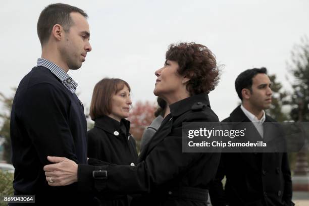 Rep. Jacky Rosen comforts Las Vegas shooting survivors Robert Gaafar , Tia Christinsen and Jason Sherman during a news conference outside the U.S....