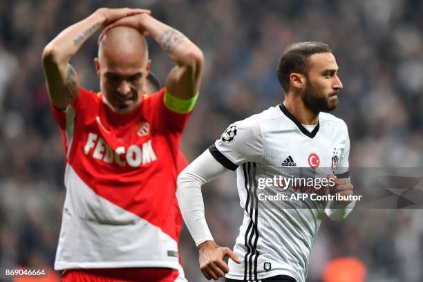 Besiktas' Turkish forward Cenk Tosun celebrates after scoring a goal next to Monaco's Italian defender Andrea Raggi during the UEFA Champions League...