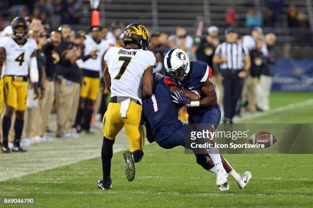UConn Huskies defensive back Tre Bell and UConn Huskies defensive back Jordan Swann collide after deflecting a pass to Missouri Tigers wide receiver...