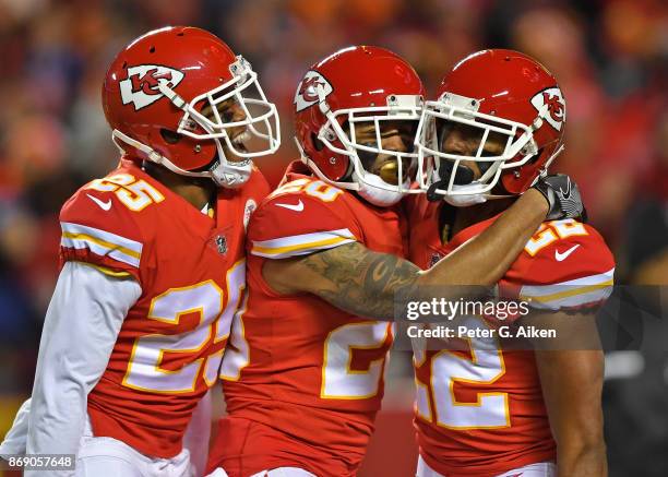 Defensive back Marcus Peters of the Kansas City Chiefs celebrates with teammates Steven Nelson and Kenneth Acker after scoring a touchdown against...