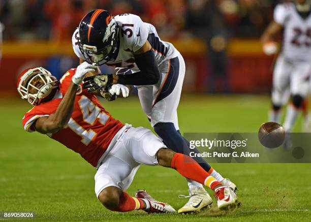 Wide receiver Demarcus Robinson of the Kansas City Chiefs can't hold onto the ball, after getting hit by safety Justin Simmons of the Denver Broncos...