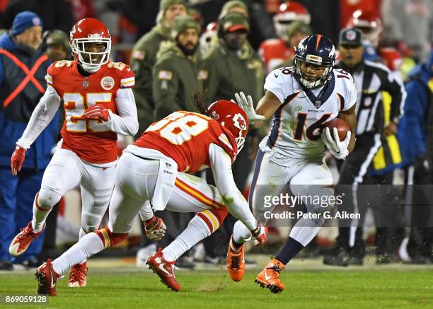 Wide receiver Bennie Flower III of the Denver Broncos runs up field after catching a pass against defensive back Ron Parker of the Kansas City Chiefs...