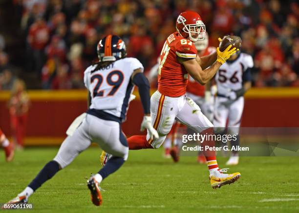 Tight end Travis Kelce of the Kansas City Chiefs catches a pass against defensive back Bradley Roby of the Denver Broncos during the second half on...