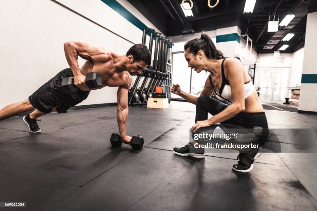 Couple of fitness models doing the pushups