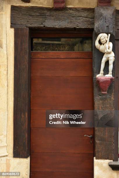 Carved figure on doorpost of house in old Plantagenet city historic district of Le Mans, Sarthe, Pays de la Loire, Northern France