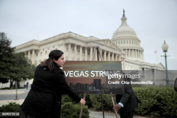 Aides set up a poster before a news conference with Las Vegas shooting survivors and members of the Nevada Congressional delegation outside the U.S....