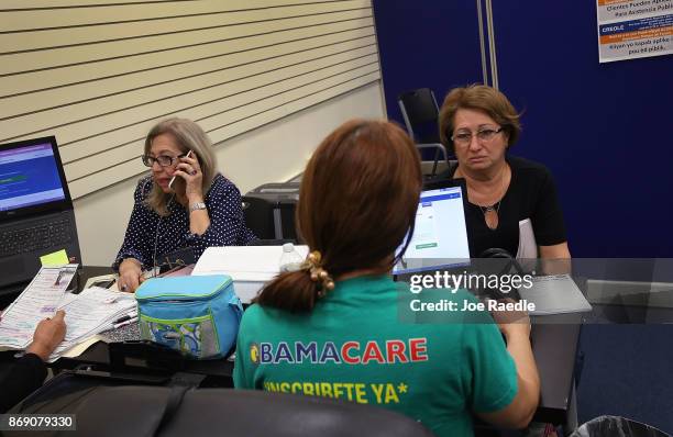 Gerardina de la Mercedes and Elena Blondin speak with insurance agents from Sunshine Life and Health Advisors, as they shop for insurance under the...